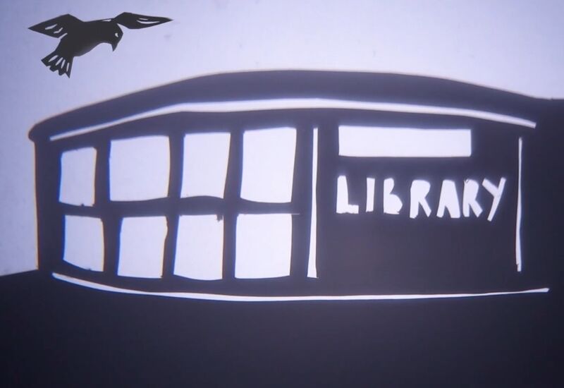 A paper puppet bird flies over a paper library