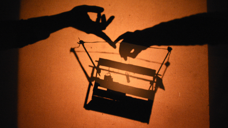 Silhouettes of objects being maniuplated