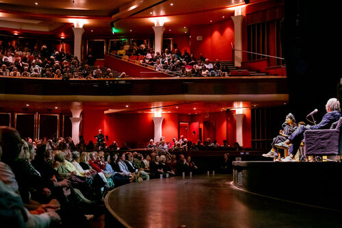 David Olusoga and Nabihah Iqbal sit in conversation at Brighton Dome Concert Hall