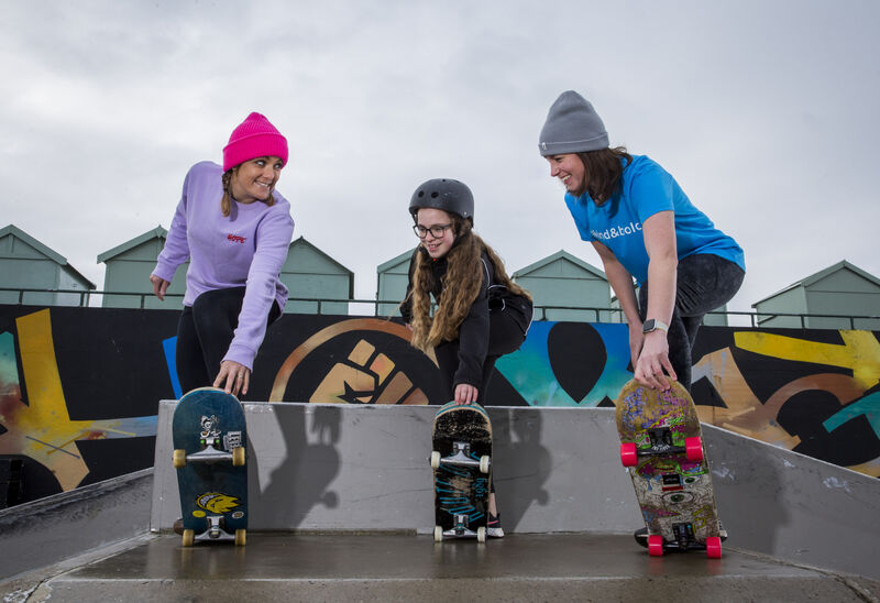 Three girls skateboarding