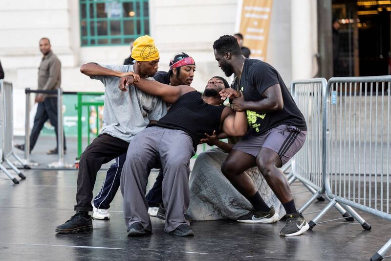 Four men support another man falling backwards