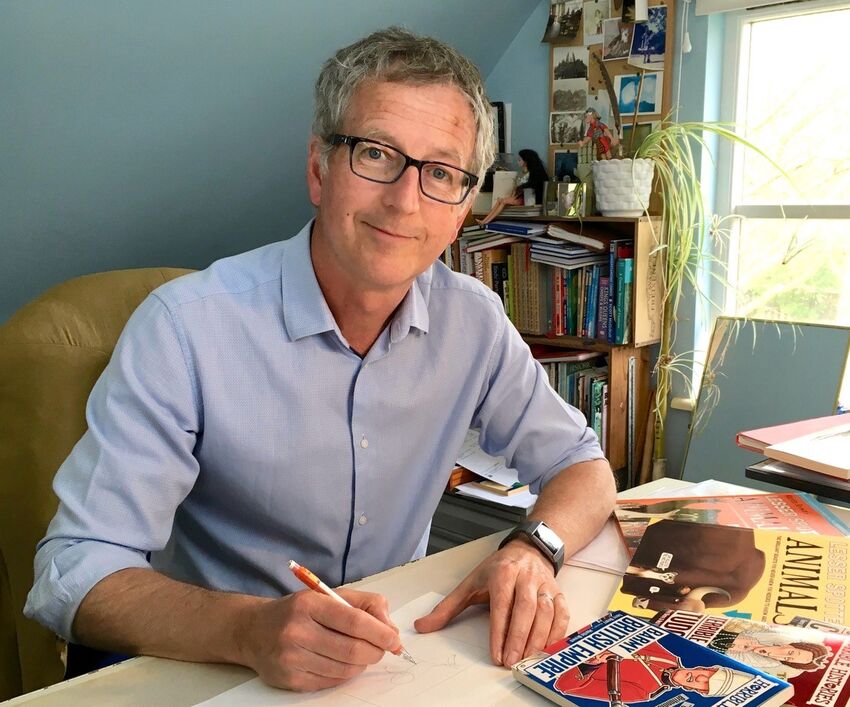 Martin Brown illustrates at his desk 