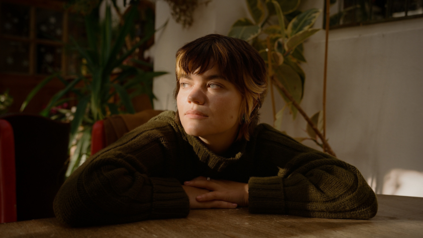 Saba Sams looking off into distance with the sunlight hitting her face