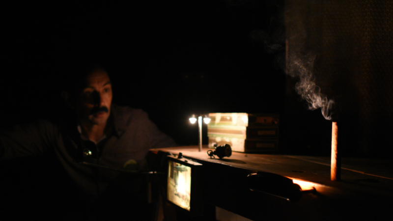 A man operating a contraption in the dark