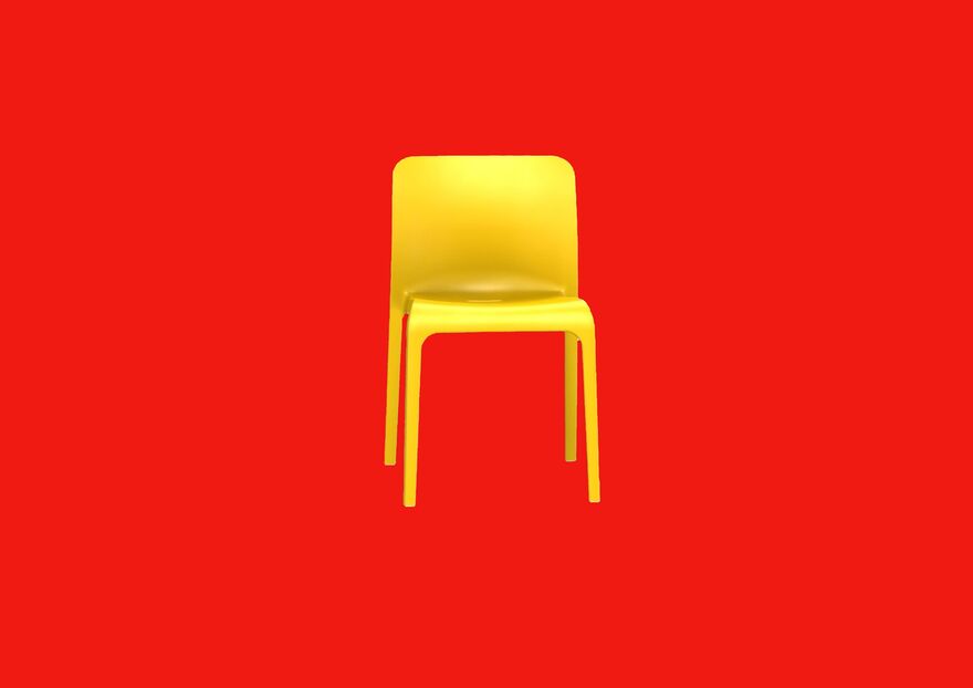 A yellow plastic chair on a red background