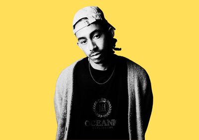 Balck and white portrait of Jordan Stephens against a yellow background