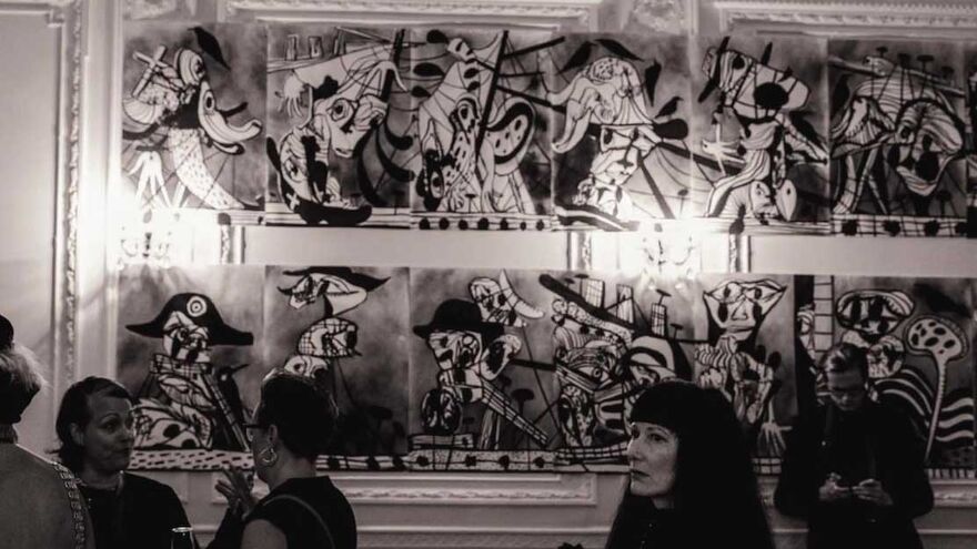 A greyscale image of gallery-like space. There are impressionistic paintings on the wall and people milling around