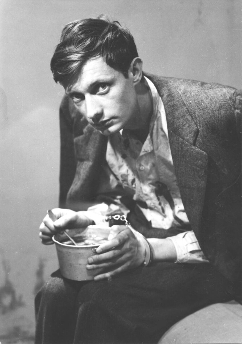Greyscale photo of a man holding a bowl of soup