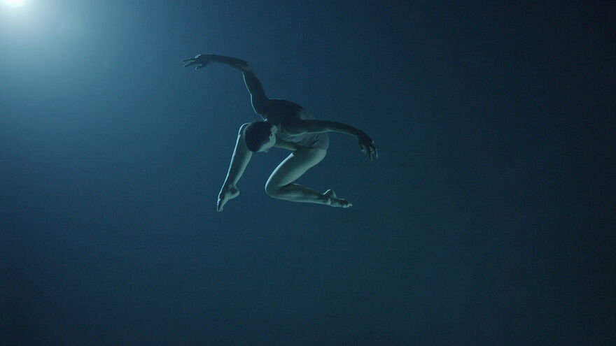 A dancer in a dynamic pose under water