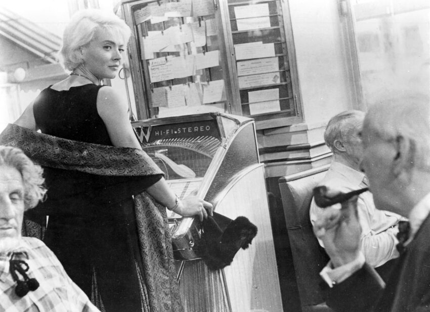 Black and White Photgrapf of French actress Corinne Marchand staring over her shoulder
