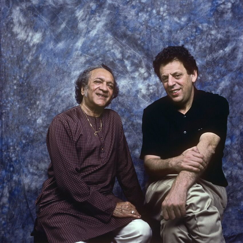 Ravi Shankar and Phillip Glass sat against a blue background