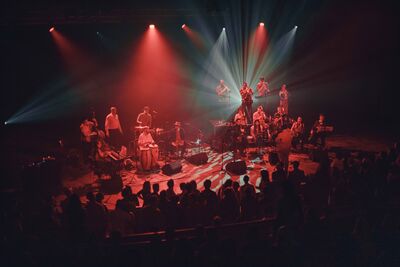 A big band on stage, lit in red