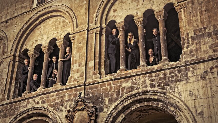 A choir stand in the upper gallery of an old church wearing black