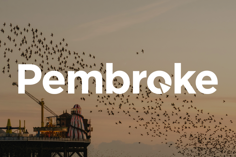 Pembroke logo layed over an image of Brighton Palace Pier and a flock of birds