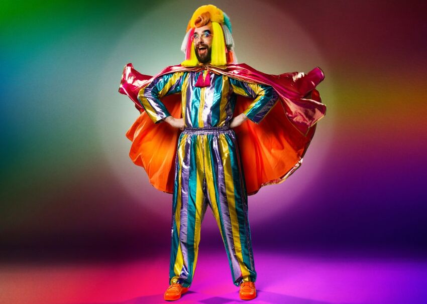 Prancer the Dancer wearing a colourful costume with a cape