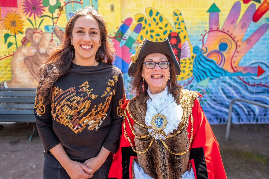 Boudicca Collins and the Mayor of Brighton and Hove, Lizzie Dean, stand in front of Boudicca's colourful mural
