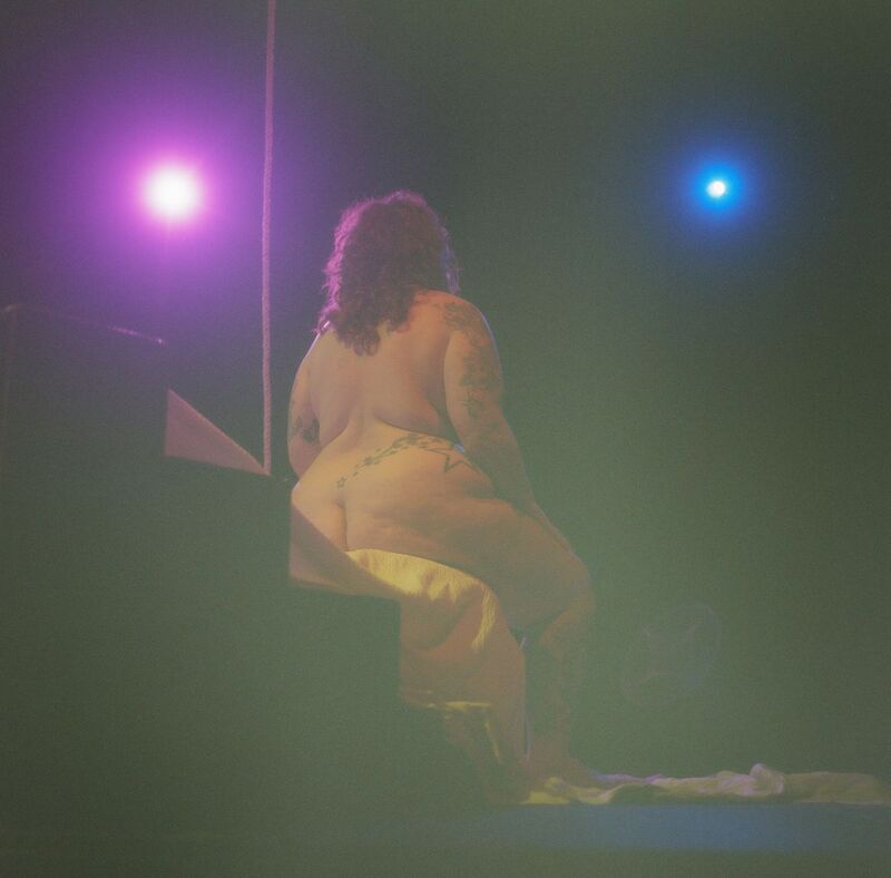 Life drawing as part of the Soft Machines process, a naked figure is sitting back to the camera in hazy light