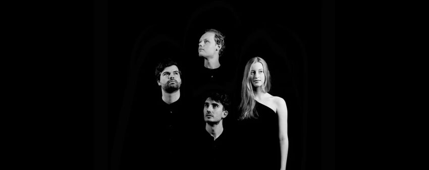 A group of four people staring off in different directions