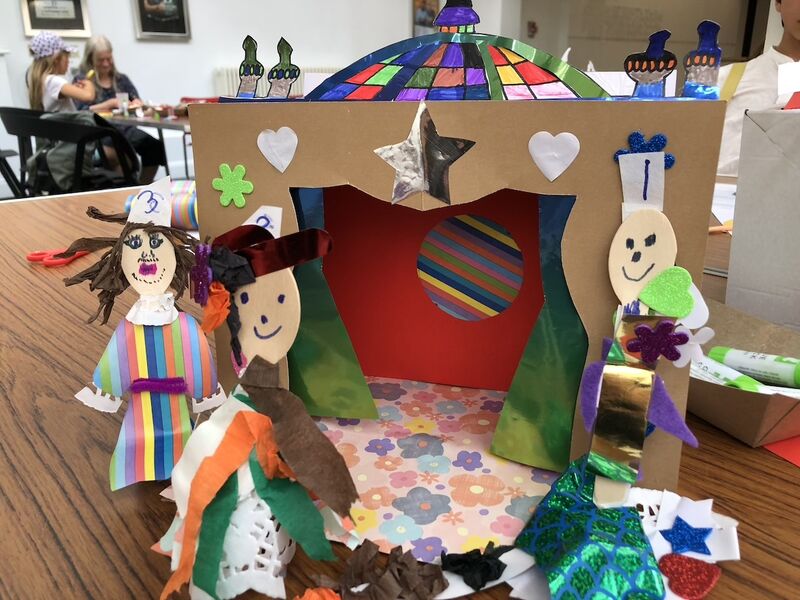 A cast of papercraft characters stand on a papercraft stage