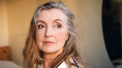 Rebecca Solnit looking off into the distance with sun shining in her face