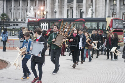 Group of people carrying chairs