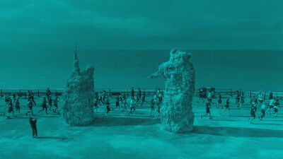 Two large sculptures on hove seafront with a park run running past